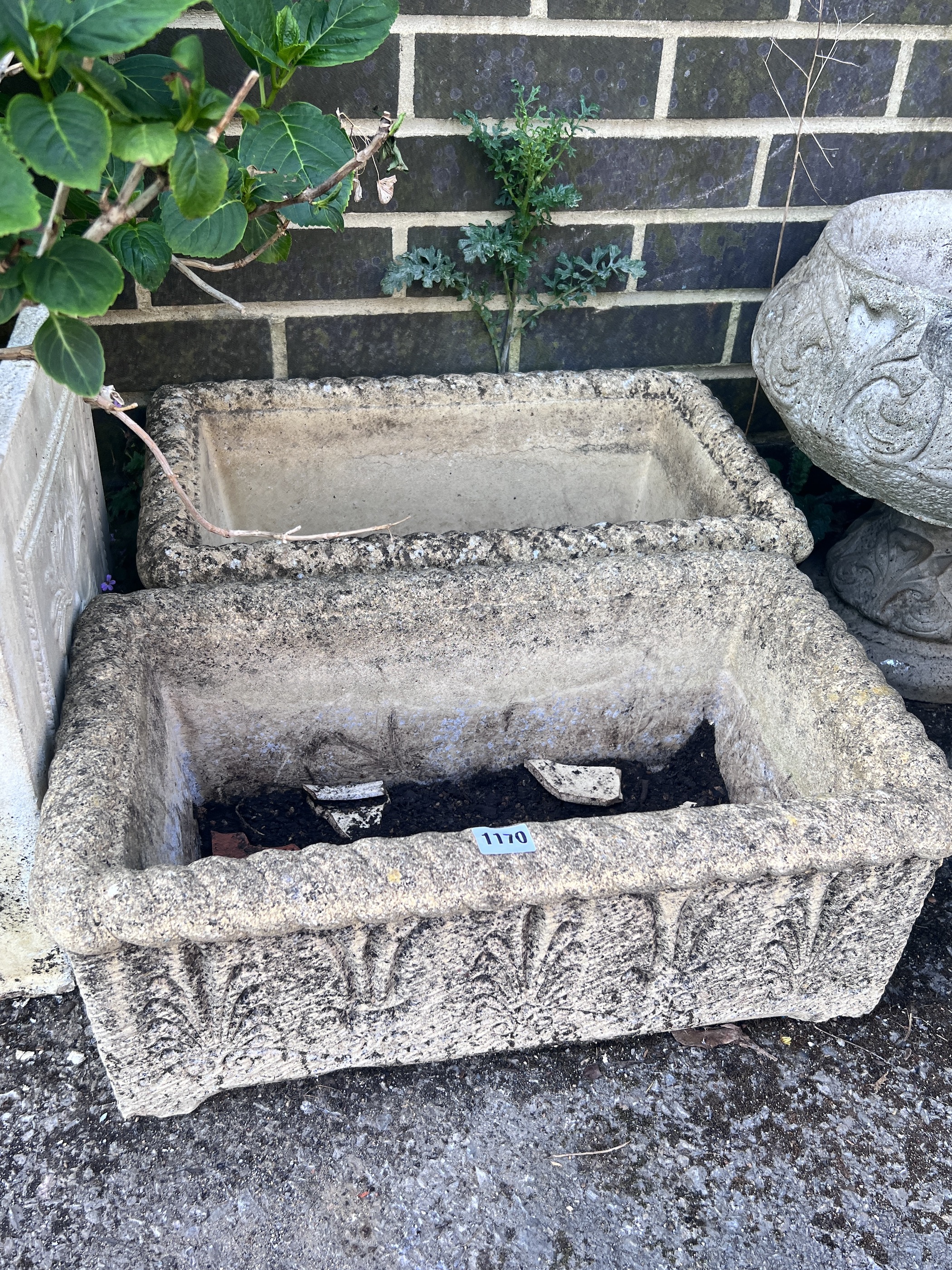 Four reconstituted stone garden planters.